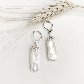 These stunning White Pearls and Silver Earrings for women make a perfect jewelry for every look and any occasion or the best holiday, anniversary and birthday gift idea for her. Leverback design doesn't hurt and looks elegant. Large size uniquely shaped freshwater gemstones are crowned with multiple small dazzling pearls round shape in a circle , forming a beautiful design to enhance your style. Enjoy lasting quality and the perfect fit!