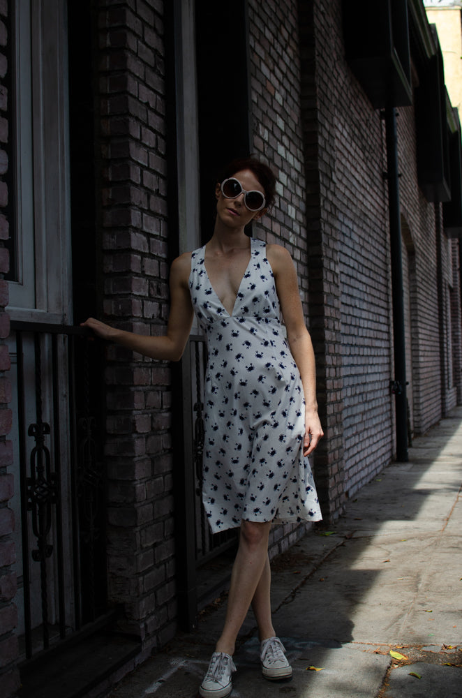 You don't need shade this summer when you wear our light easy A-shape Cotton dress in Blue Crab print. Open shoulders design is exquisite. Bra shaped top connecting to wide straps that cross in a back  looks exquisite along with that beautiful deep V heckling in front. Don't you think so?