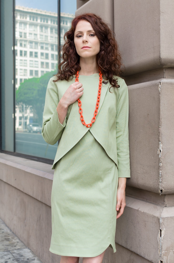 Jessie is modeling a perfect set, our Overlapping Front Jacket and matching Drop Sleeve Scallop Hem Dress in Sage Green. And the orange beads for fun!