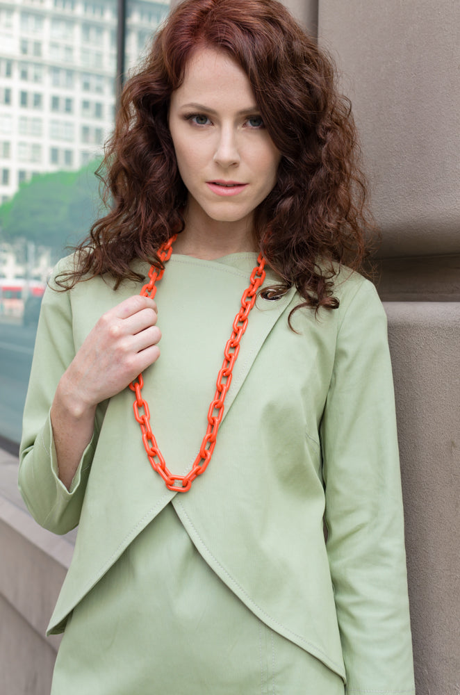 Up close look at our beautiful set, Overlapping Front Jacket paired with Drop Sleeve Scallop Hem Dress in Sage Green. What a beautiful accent, long chain necklace in orange.