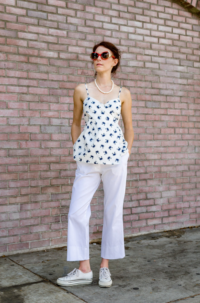Front view of our Ankle Wide Hem Pants in White paired with our Wrap Empire Tank Top in Navy Crab. Cute, isn't it?  Just a perfect outfit to get lazy, put your hands in those pockets, like you don't care. Isn't it what the summer is about?