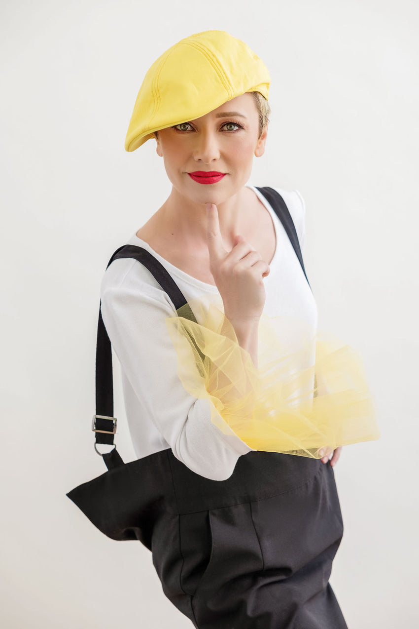 Yellow does not have to be your favorite color to fall in love with our one of a kind top in Sunny Side Up. Creatively trimmed with tulle ruched cuffs this unique piece will set you apart from everyone else. And whether it's paired with a jacket or worn by itself, it is nothing else, but FUN!