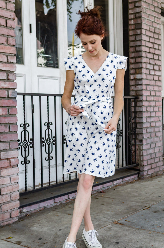 One and two, I count to blue. In this adorable cotton dress with bow tie in a back, you'd feel summer all year long! Stop by our boutique and take it home today!